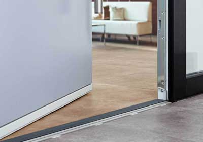 Close-up of a door threshold showing its role in sealing and protecting entryways